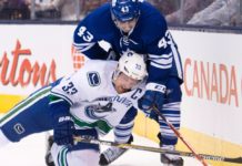 Nazem Kadri of the Toronto Maple Leafs battles Daniel Sedin of the Vancouver Canucks