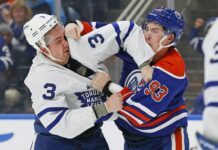 Justin Holl, Toronto Maple Leafs fight vs Ryan Nugent-Hopkins of Edmonton